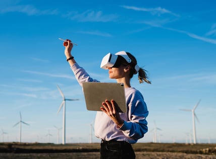 Woman using a virtual reality headset while inspecting wind turbines under a clear sky - Nexusmind